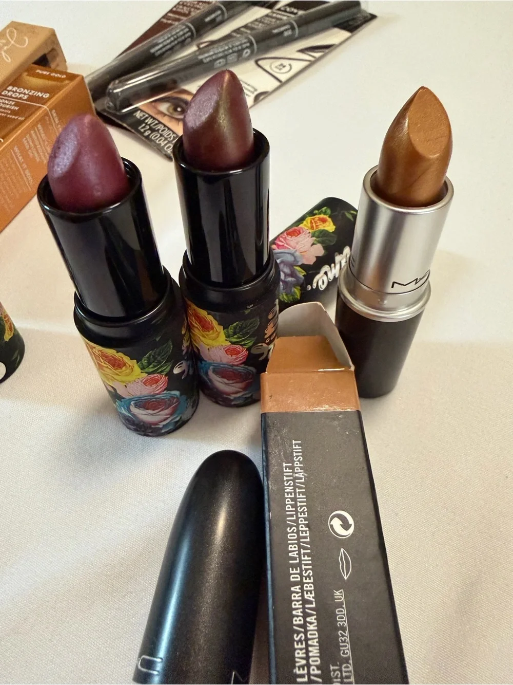 Assortment of women’s lipsticks, eyeliner, eyeshadow, bronzing drops